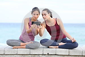 Attentive yogis watching yoga tutorial on phone