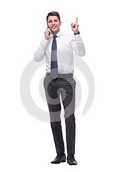 Attentive young businessman talking on mobile phone. isolated on white