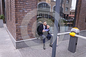 Attentive young office worker eating his sandwich