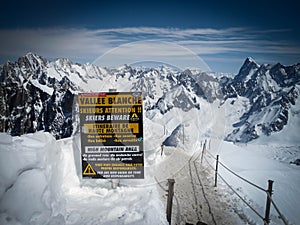 Attetion sign label in Vallee Blanche, Chamonix, France in summer