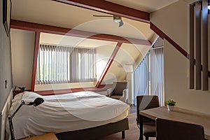 Attic bedroom, cosy double room in hotel, interior design