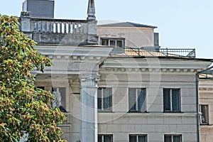 Attic of a large old stone stone house with a row of windows and concrete columns