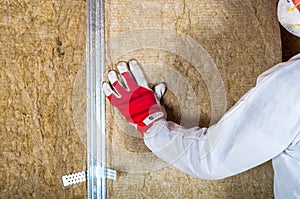 Attic loft insulation by hand photo