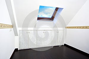 Attic room with roof skylight window photo