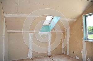 Attic room under construction with gypsum plaster boards
