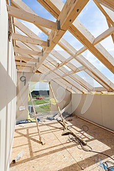 Attic room under construction with gypsum plaster boards. Roofing Construction Indoor. Wooden Roof Frame House Construction