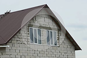 Attic of a white brick house with two windows