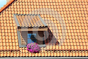 Attic window in orange tiled roof