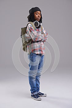 Attitude, crossed arms and portrait of child on gray background with headphones for song, audio and radio. Student