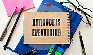 Attitude Is Everything text torn from boxes of paper