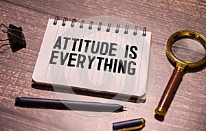 Attitude Is Everything text torn from boxes of paper