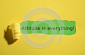 Attitude Is Everything text on torn paper