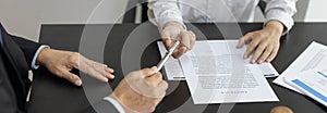 Attorney or lawyer handing client a pen to sign a business contract