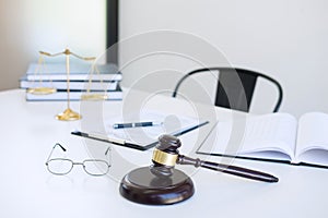 Attorney`s suit, Law books, a gavel and scales of justice on a w