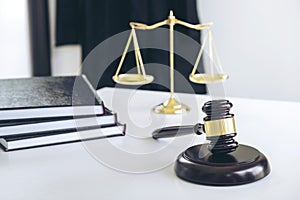 Attorney's suit, Law books, a gavel and scales of justice on a w