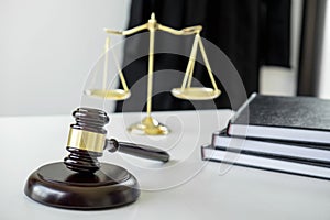 Attorney`s suit, Law books, a gavel and scales of justice on a w