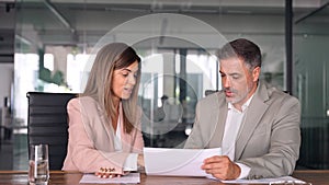 Attorney showing document to client providing legal consultancy services.