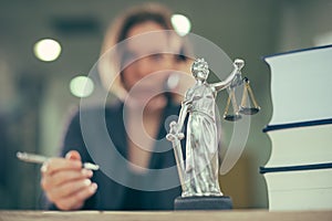 Attorney woman talking on mobile phone from her office desk