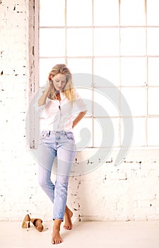 Attracive blond woman relaxing by the window