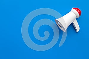 Attract attention concept. Megaphone on blue background top view copy space