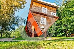 Attraction Upside down house, a house that stands on the roof, a funny house upside down in a park, upside-down