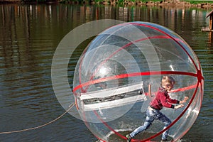 Attraction on the water, ZORB, the boy in a bowl on the water. Water attractions, rest, vacation, vacation