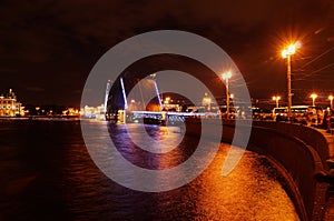 Attractions in the city of St. Petersburg in Russia, the embankment of the Neva River with a bridge and the light reflected there