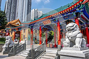 Attractions and sculptures of Wong Tai Sin Temple against the modern skyscrapers, Hong Kong