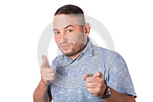 Attractive adult man with stubble in summer shirt shows a finger in your face