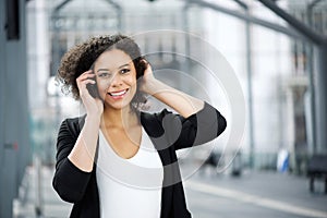 Attractive african american business woman smiling with cellphone