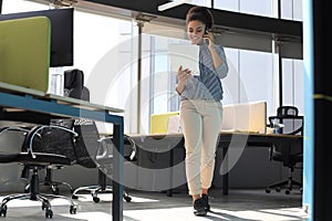 Attractive african american business woman talking with collegues on the mobile phone