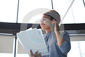 Attractive african american business woman talking with collegues on the mobile phone