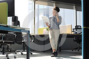 Attractive african american business woman talking with collegues on the mobile phone