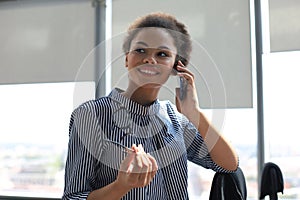 Attractive african american business woman talking with collegues on the mobile phone