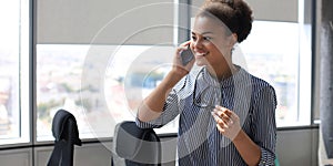 Attractive african american business woman talking with collegues on the mobile phone