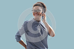 Attractive african american business woman talking with collegues on the mobile phone on the blue background.