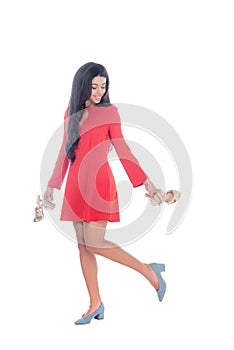 attractive african american girl in red dress holding sandals with heels isolated