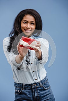 attractive african american girl showing red gift box