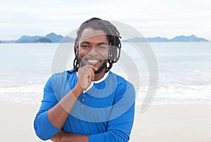 Attractive african american guy with dreadlocks at beach