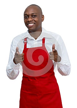 Attractive african american waiter with red apron