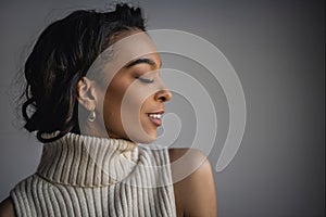 Attractive african american woman against grey background