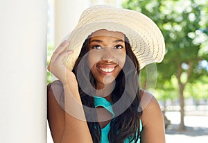 Attractive african american woman smiling with sun hat