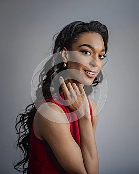 Attractive african american woman wearing red dress against grey background