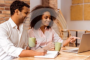 Attractive Afro-American couple working