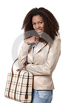 Attractive afro woman with handbag smiling