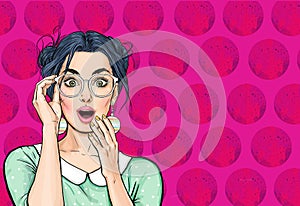 Attractive amazed young woman  with mobile phone in hand. Wow girl in comic style. Pop art woman holding smartphone.
