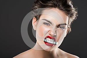 attractive angry woman holding money in teeth