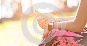 Attractive anonymous sportive woman wearing smart watch showing thumb up after workout session