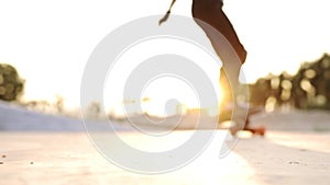 Attractive Asian boy with safety skateboarding knee pad skating at skateboard park.