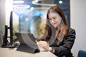 Attractive Asian businesswoman working in office